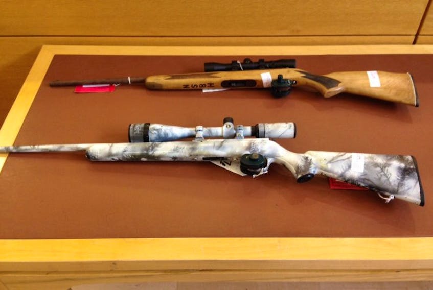 Two of the guns seized after a shooting on Christmas Day in 2015 are shown on an evidence table in P.E.I. Supreme Court on Thursday. Matthew Lindsey Clarke and Brodie Joseph McQuaid were shot with the .22-calibre shown in the top of the photo. 