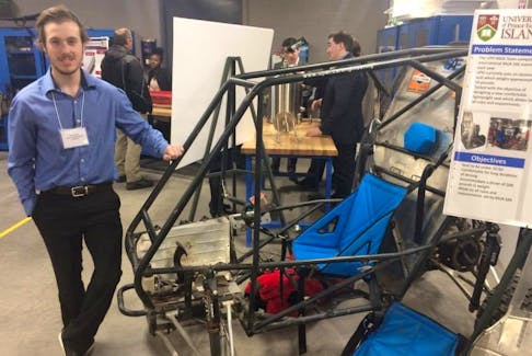 Evan Dixon stands with a cart, whose lightweight seat he helped design. Dixon’s cart was one of several environmentally friendly ideas on display Friday at the Green Expo at UPEI.