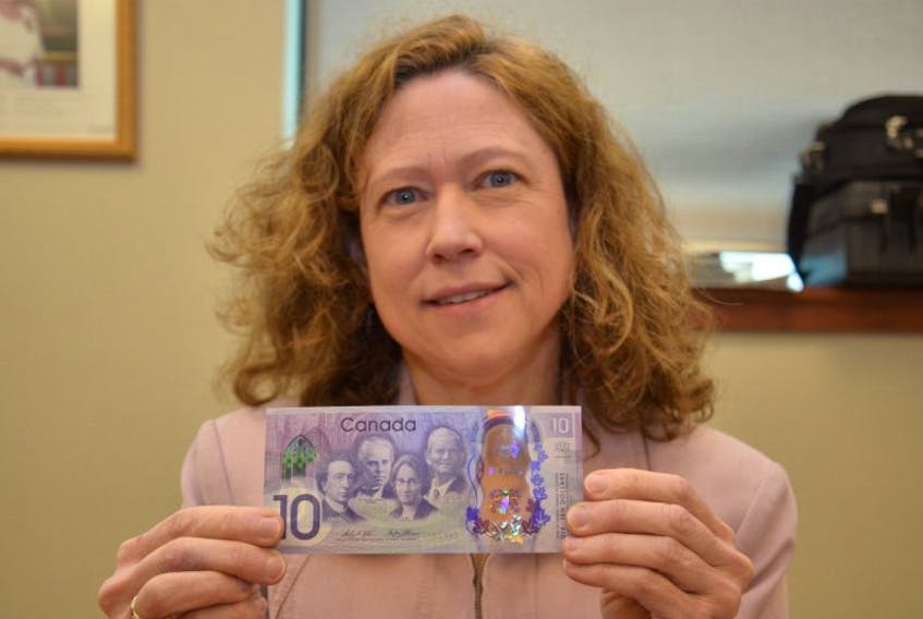 Monique LeBlanc, regional director of currency for the Bank of Canada, holds a new $10 Canadian bank note. The limited edition notes will go into circulation on June 1 and are meant to celebrate Canada’s 150th anniversary. 