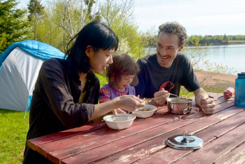 Tomona Morrita, left, and Guillaume Landry enjoy some breakfast with their daughter Tami Landry, 4, at the Cornwall/Charlottetown KOA campground this weekend. The campground was one of the few open for the long weekend, which was an ideal time to get out for those craving the outdoors.