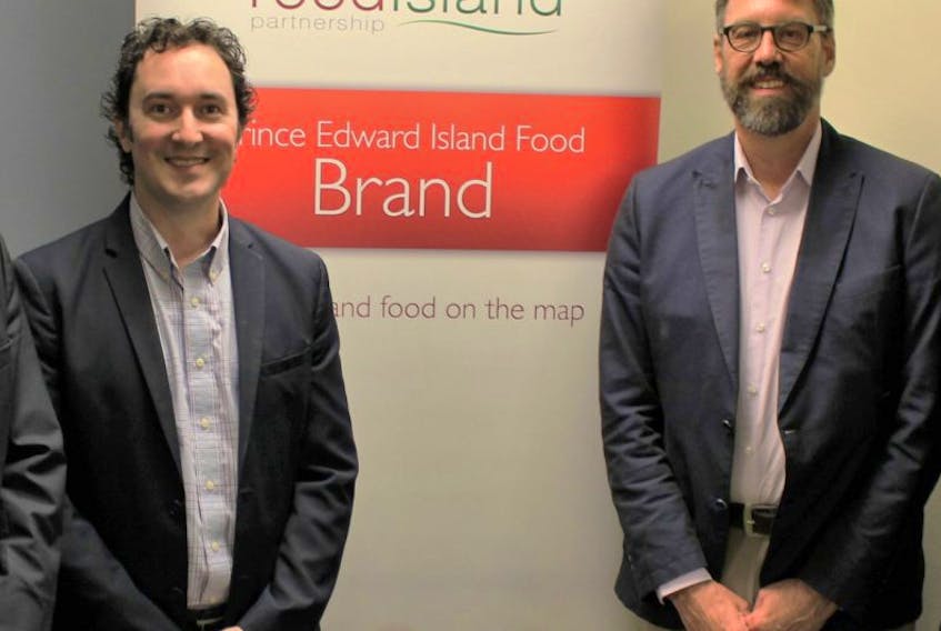 John Rowe, left, and Bryan Inglis are shown at a meeting in Charlottetown Friday that focused on the role food plays in Atlantic Canada’s economy.