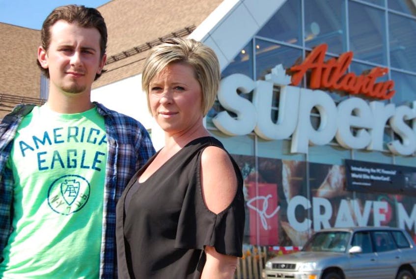 Charlottetown's Sheila Cormier and her son Tyler pose in front of the Atlantic Superstore in Charlottetown where chicken she claims caused Tyler food poisoning was purchased.