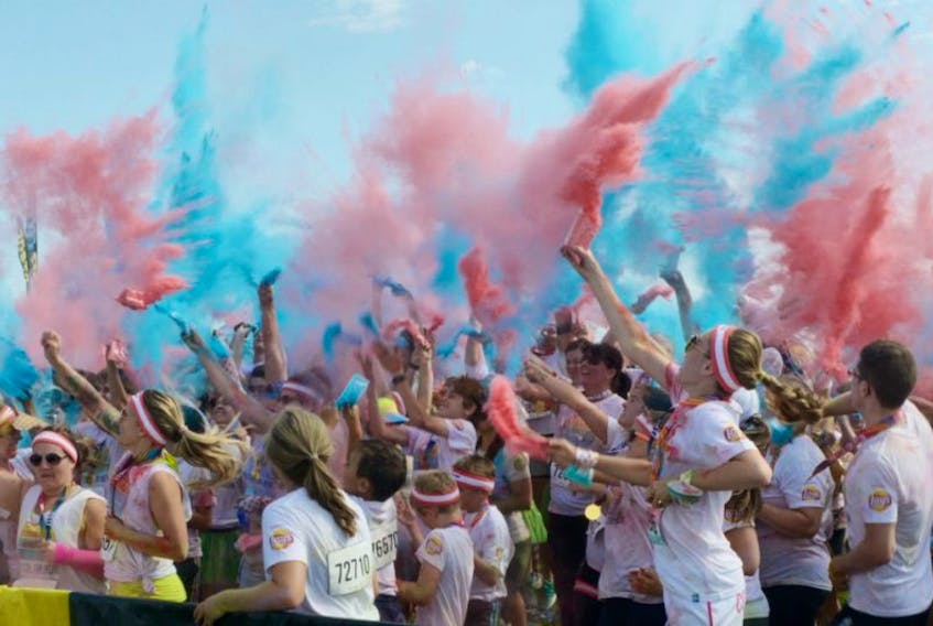 Participants in The Color Run held at the Charlottetown Event Grounds and throughout the streets of the city on Saturday dance during a post-run concert while throwing bags of brightly coloured corn starch. The event brands itself as “the happiest 5K on the planet.”