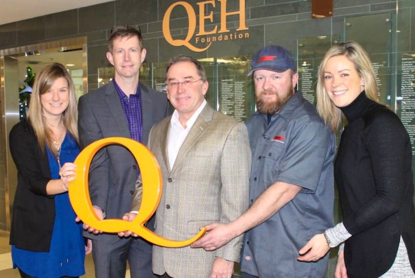 From left, Heather MacAulay, DME, Steve Dunne, QEH Foundationboard of directors, Peter Toombs, DME, Rob Judson, DME and Lucy De Jong, DME, gather during an announcement that the company has reached its goal of donating $100,000 to the Charlottetown hospital.