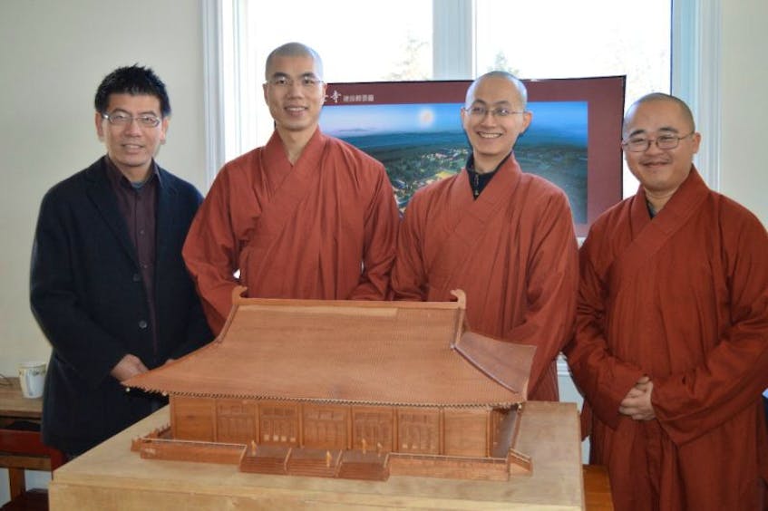 A major expansion of the Buddhist monks monastery in Heatherdale is underway. The project includes a large temple for the monks to pray in. A model of what the temple will look like is pictured here. From left, are Geoffrey Yang, spokesman for the Great Enlightenment Buddhist Institute Society (GEBIS); Venerable Xing-Zi; Venerable Xing-An; and Venerable Xing-Mao.
