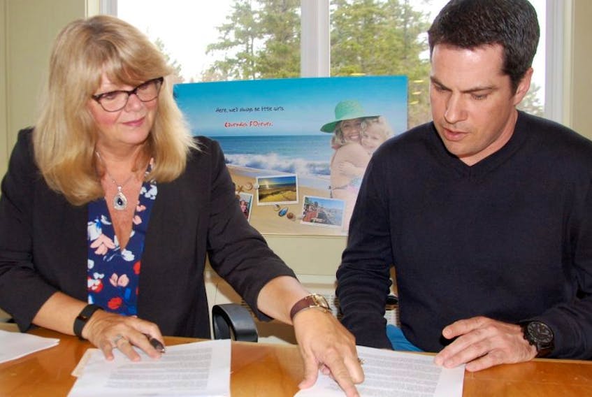 Tourism Cavendish Beach president Sandi Lowther, left, and executive director Darcy Butler look over some notes prior to the group’s spring general meeting Tuesday night at the Cavendish Visitor Information Centre.