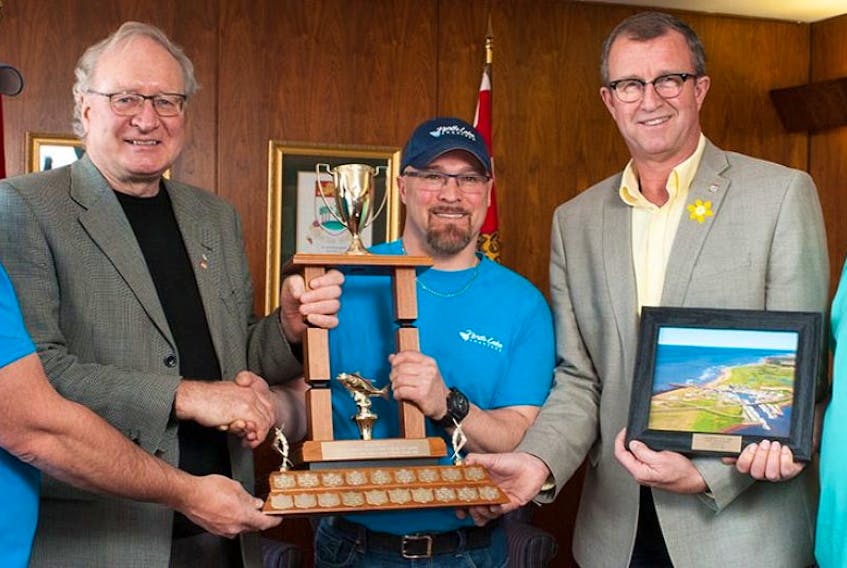 The Premier's Tuna Cup winner is Captain Ross Keus, centre, of North Lake, who landed the largest bluefin tuna in 2016. On hand for the presentation are Premier Wade MacLauchlan, left, and Fisheries Minister Alan McIsaac. 