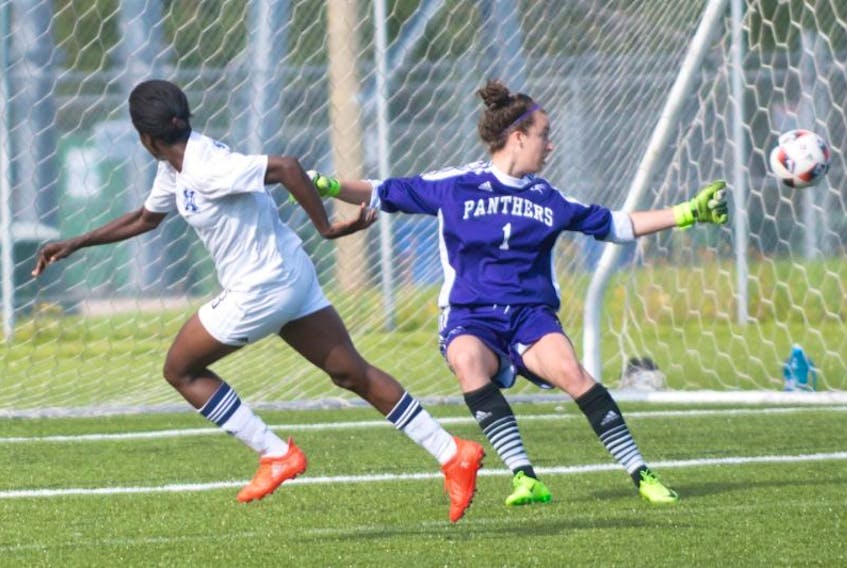 BRIAN MCINNIS/THE GUARDIAN

Mercy Myles of the St. F.X. women gets the ball past Panther goalkeeper Amanda Stanyer during action Saturday at UPEI.