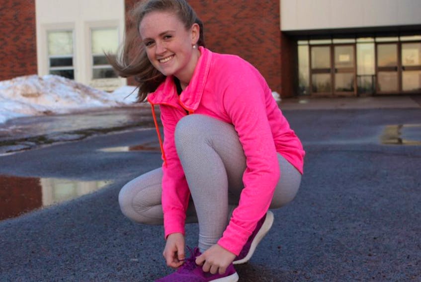 Emma MacKenzie, 17, laces up her running shoes as she prepares to go for a run after school.
