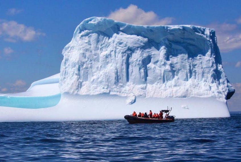 A tour boat cruises pass an iceberg off the coast of Bonavista, N.L. in this undated handout image. Photos of spectacular icebergs on social media are drawing visitors from all over the world to Newfoundland and Labrador. 