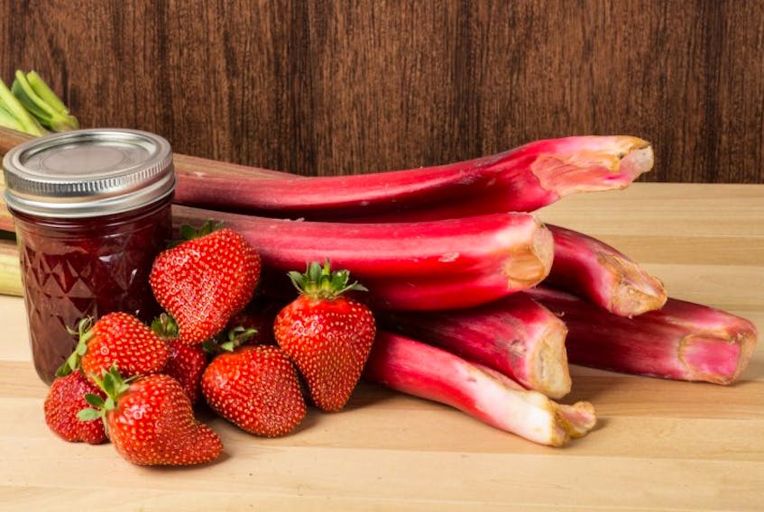 Strawberry rhubarb jam or jelly with fresh strawberries and rhubarb
