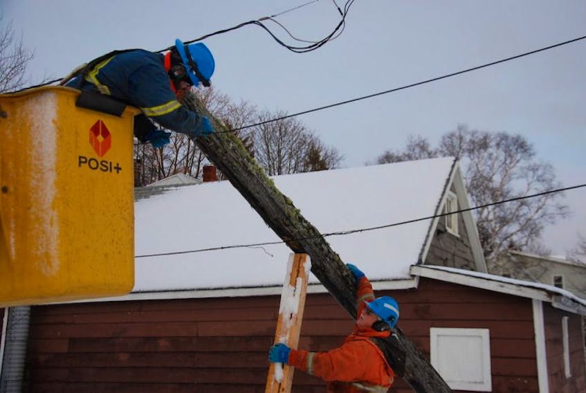 Jarrod Vessey mans the bucket as Scott Lowther directs from below as the Maritime Electric workers deal with a broken hydro pole in Hazelbrook Monday. Sunday’s storm knocked down at least 100 poles and knocked out power to more than 12,000 customers.