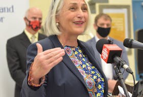 Joanne Thompson, executive director of The Gathering Place speaks during a news conference Thursday. In the background are Education Minister Tom Osborne (left) and Premier Andrew Furey. BARB SWEET/THE TELEGRAM