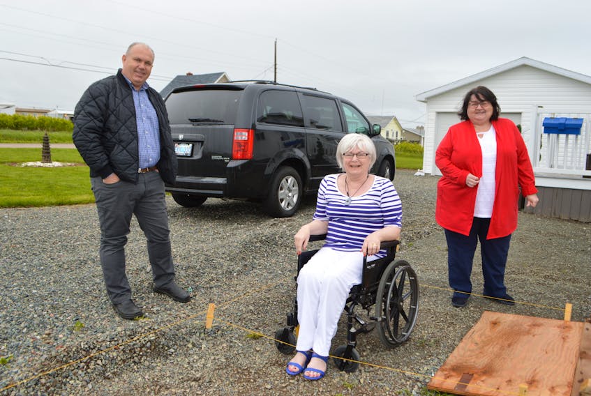 Wendy Littlejohn, centre, at her home in New Waterford, with friend Blair Slade of Glace Bay, and Pam Leader, executive director of the Savoy Theatre in Glace Bay. After suffering a stroke in March and no longer able to drive, Littlejohn donated her van to the Savoy Theatre. Sharon Montgomery-Dupe/Cape Breton Post