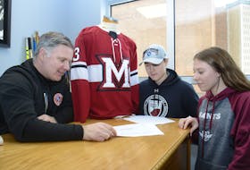 Kenny MacDougall, headmaster at The Mount Academy, explains plans for a new campus in North Rustico for its grades 9-12 students to Keefe Marshall and Meg Aiken Thursday in Charlottetown.
