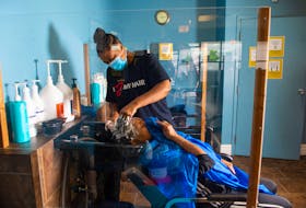 Tracey L. Crawley washes Darlene Paris's hair inside Crawley's Crowning Glory salon in Dartmouth on Tuesday. Ryan Taplin - The Chronicle Herald