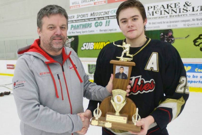 <p><span class="Normal">Spud AAA Minor Hockey Tournament co-chair Andrew Hall, left, congratulates Charlottetown Abbies defenceman Bobby Jamieson on winning the Drew Power Leadership Award during the final day of the Spud championship Sunday. Jamieson was presented with the award prior to Sunday's Midget AAA championship game, which his team also won 3-1.&nbsp;</span></p>
<div><span class="Normal"><br /></span></div>