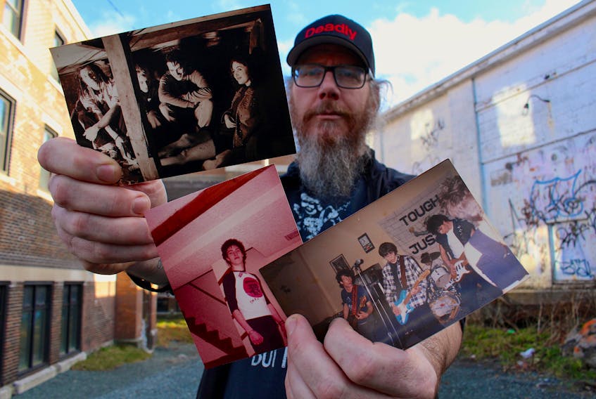 Geoff Younghusband, a longtime friend of John Fisher, holds pictures of Fisher from throughout his life. The band in the photo on the left is Potmaster, which featured (from left to right) Younghusband, Tony Tucker, Fisher and Natalie Noseworthy. The band on the right is Tough Justice and featured (left to right) Dean and Rod Locke, Llewellyn Thomas and Fisher. — Andrew Waterman/The Telegram