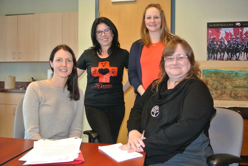 (Front, from left) Sarah MacMaster of Maggie’s Place Family Resource Centre, Dawn Ferris from Autumn House, (back, from left) Rene Ross from the Sexual Health Centre for Cumberland County and Sarah Pennoyer from the Cumberland District RCMP look over plans for Family Violence Prevention Week and Sexual Health Awareness Week in Cumberland County between Feb. 9 and 15. Darrell Cole – Amherst News