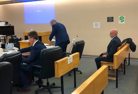 Robin McGrath (right) waits for his lawyers, Ian Patey and Tom Johnson, after his trial in provincial court adjourned for lunch Monday. TARA BRADBURY/THE TELEGRAM