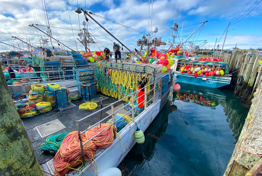 Lobster traps are loaded onto a boat at the Pinkney's Point, Yarmouth County, wharf in late November. TINA COMEAU PHOTO