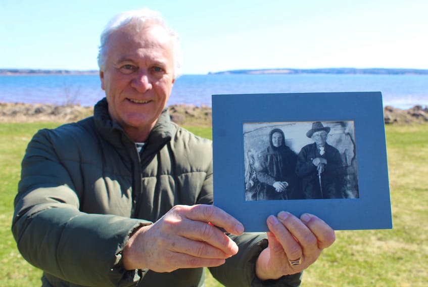 Acadian historian Georges Arsenault holds a photo of his maternal grandfather's grandparents, Léon Poirier and Marie Bernard. they were married in Tignish in 1846 and had 16 children, six of whom died in infancy. In 1915, they celebrated their 69th wedding anniversary, and Léon died later that year at the age of 96. He was a great-grandchild of Pierre Poirier.