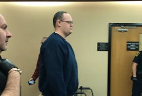 Matthew Twyne stands as Judge Colin Flynn enters the room at Provincial Court in St. John’s Monday morning, at the start of Twyne’s sentencing hearing for committing an indecent act and breaching two court orders.