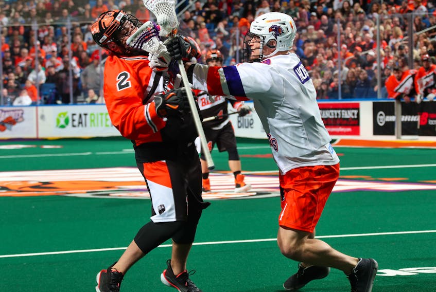 Halifax Thunderbirds defender Graeme Hossack, right, gets his stick up on Buffalo Bandits forward Chris Cloutier during a National Lacrosse League game in Buffalo, N.Y., on Saturday. (HALIFAX THUNDERBIRDS)