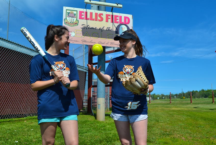 Lauren Lilly, left, and Ally Hustler, members of the Township Tigers discuss strategy heading into the Eastern Canadian women’s softball championship. The Tigers host the four-team tournament on O’Leary’s Ellis Field from Friday to Sunday.