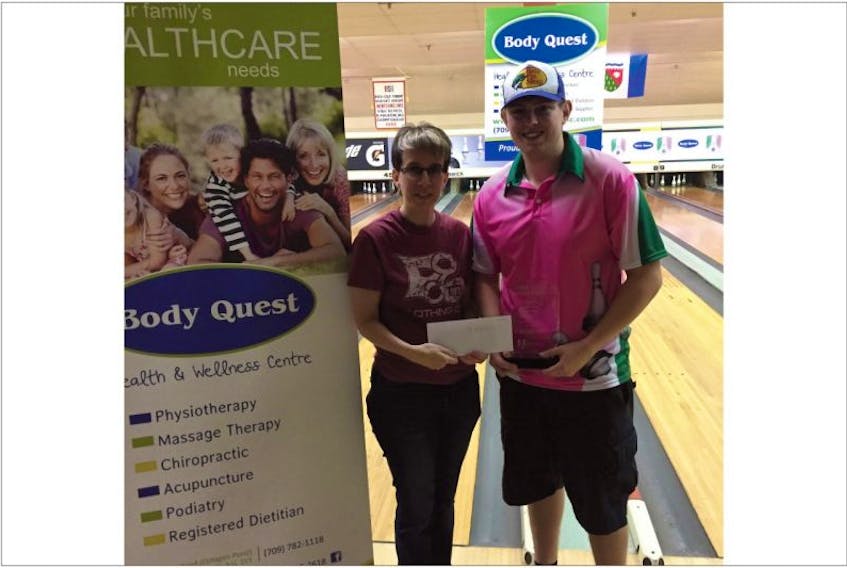 Brandon Tibbs, who won the singles title at the inaugural NBT Challenge five-pin bowling event over the weekend, is presented his cash winnings and trophy by the Newfoundland Bowling Tour president Melissa Manor.