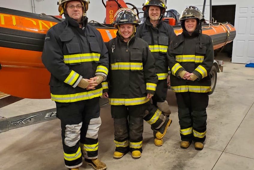 The Tidnish Bridge Fire Department is raising money to support the purchase of two new engines for its Zodiac rescue boat. Shown by the boat are, from left, fire chief Andy Fullerton, volunteer Kelly Spicer, trustee Gunter Holthoff and deputy chief Allison Holthoff. Contributed

