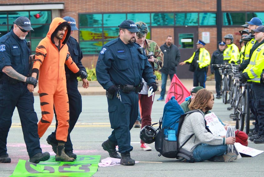 Halifax police arrest a climate crisis protester Monday, Oct. 7, 2019 after he, along with a small group of other people, refused to end their blockade of the Macdonald bridge in Dartmouth. - Tim Krochak