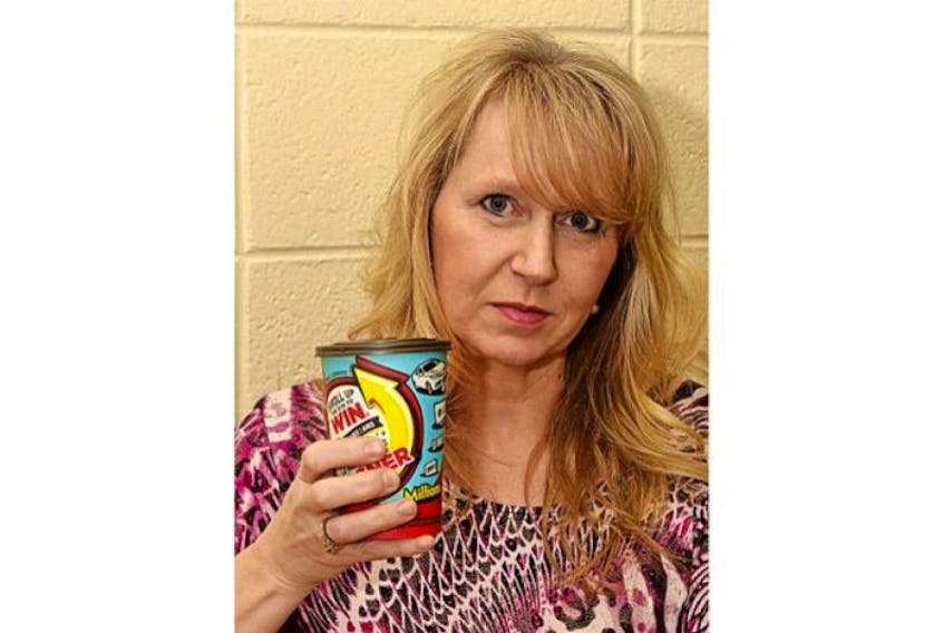 Newfoundland and Labrador resident Margaret Coward holds a cup of Tim Hortons coffee Feb. 22. A few days earlier, &nbsp;she purchased a coffee at Tim Hortons and won a $100 gift card. She posted a photo of the winning cup on Facebook and someone used the PIN code to claim the prize