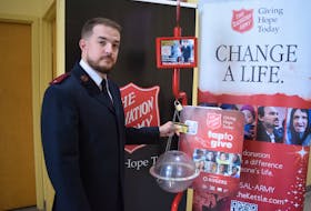 Lt. Matthew Reid making a donation using the new tiptap devices located at The Salvation Army's Christmas Kettles. The machines allow people to donate using their debit or credit card in $5 increments. 