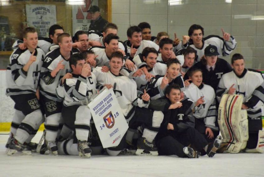 Members of the NKEC Titans hold the regional banner March 9 in Berwick after winning the final 4-2 over Yarmouth. 