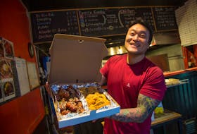 Joungmin Kim, owner of Backoos Korean Food To Go, holds up an order of Half-and-Half Chicken -- comprised of one whole chicken, one side is sweet and spicy the other, regular --in this file photo taken at his Bedford Highway establishment. A new Backoos outlet is coming to Tacoma Drive in Dartmouth. Tim Krochak/The Chronicle Herald/File