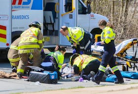 Halifax firefighters and EHS paramedics, attend to a cyclist who was struck by a vehicle on Cleary Street at Alderney Drive in Dartmouth on Tuesday, May 7, 2019.