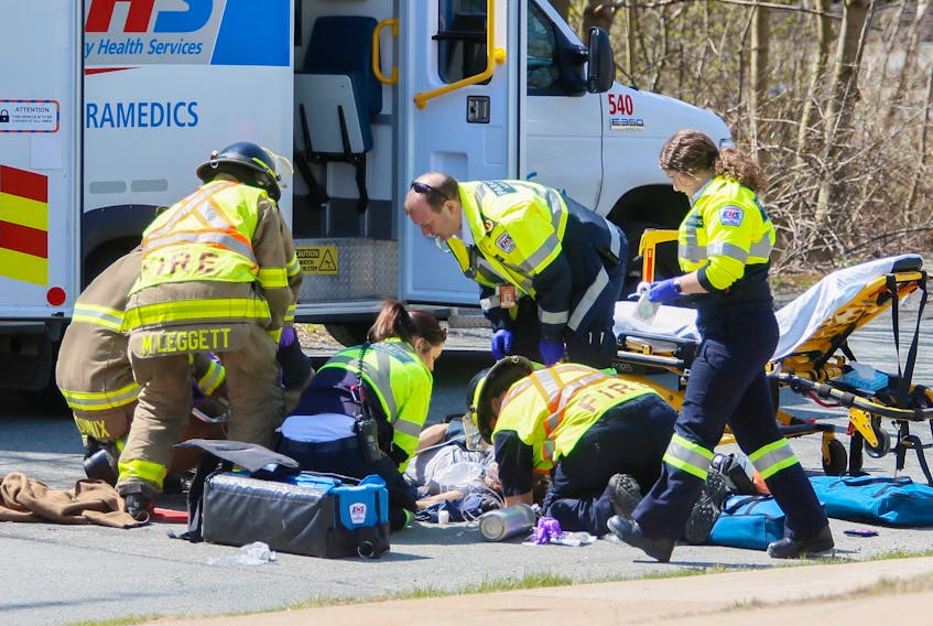 Halifax firefighters and EHS paramedics, attend to a cyclist who was struck by a vehicle on Cleary Street at Alderney Drive in Dartmouth on Tuesday, May 7, 2019.