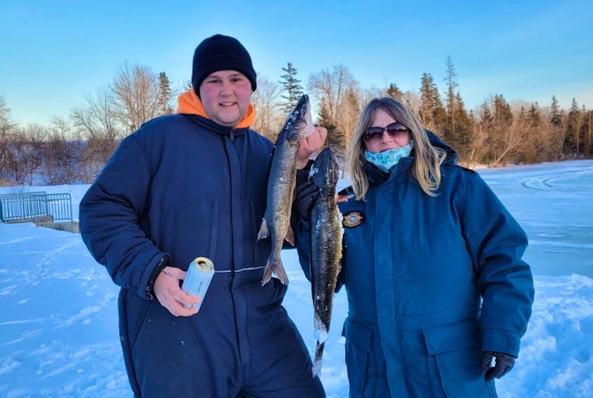 Rosaleen Hutchinson and her son Quinten Bennett hold the fish they caught at the recent Shortts Lake Ice-Fishing Derby. CONTRIBUTED