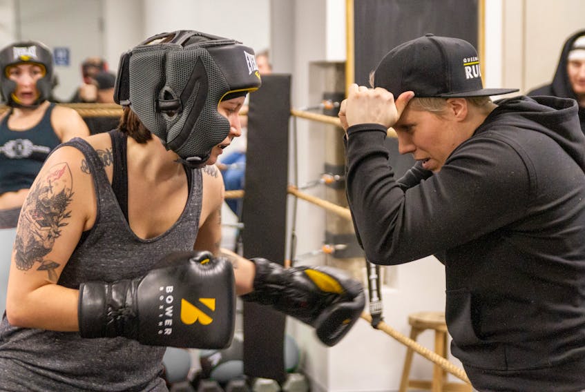 Laura MacPhee, right, takes on Lacy Lalonde during a sparing certification session. PATRICK FULGENCIO
