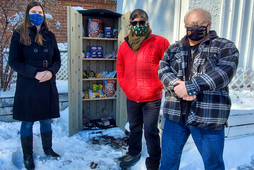 From left, Nicole Mosher, Fairview Resource Centre board member Mohammad Ehsan and initiative co-organizer Dave Aalders stand at the newly launched community food cupboard in Fairview. Two have been installed, one at the Fairview Resource Centre and another at Al-Barakah Mosque. CONTRIBUTED