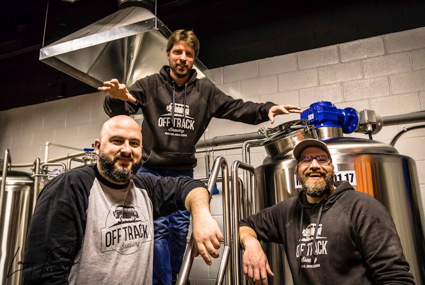 Instead of viewing down time caused by COVID-19 restrictions as a negative, Off Track Brewing co-owners Allan MacKay, left, Jon Saunders, centre, and Matt Scott used it as an opportunity to make renovations and expand their indoor space. Larry Peyton Photography