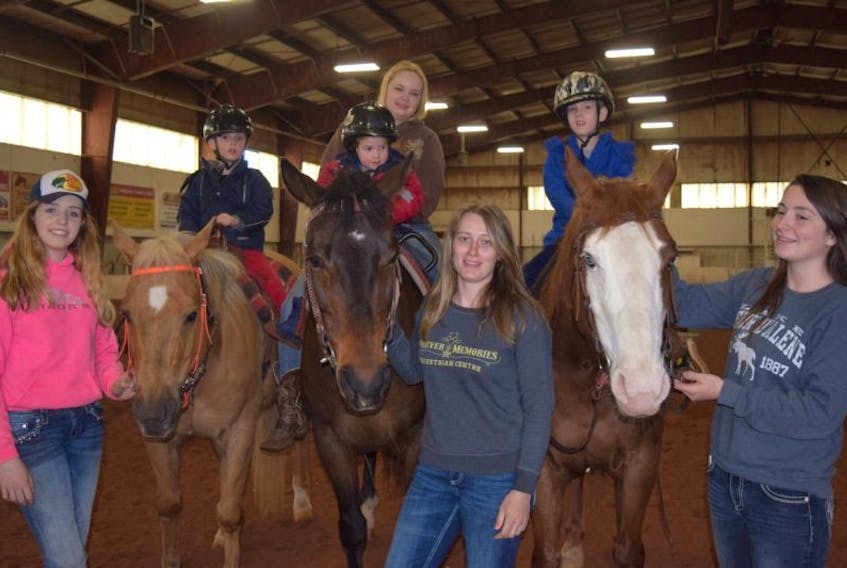 The Deighton brothers enjoy their time in the saddle. Standing, from left, are volunteer Jordan Fillmore, Forever Memories Equestrian Centre owner Shelby Gatti and volunteer Rileigh Conrod. In the saddle are William, Jamie and Robert Deighton, along with volunteer Amanda Harnish..