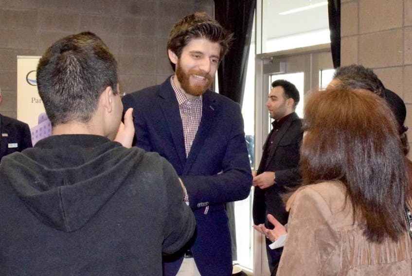 Tareq Hadhad, a former Syrian refugee who has resettled with his family in Antigonish, is seen chatting with well wishers following a presentation to a Chamber of Commerce audience this week in Truro.