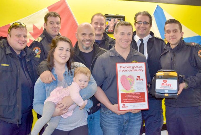 Members of the Truro Fire Services Ryan Thibeau, Bloise Curry, Logan Daly, Josh Chisling and Craig Matthews presented a defibrillator to Micky Marshall of MARMAC Athletics in memory of Cody Glode. Cody’s father Matthew, sister Caitlyn and niece Piper attended the presentation.