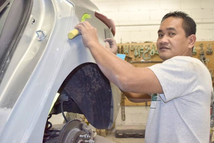 Marvin Dabu, a body repair worker at the Pye Chevrolet Buick GMC dealership in Truro, is hoping to soon bring his family to Canada from the Philippines after recently receiving his permanent residency status here.