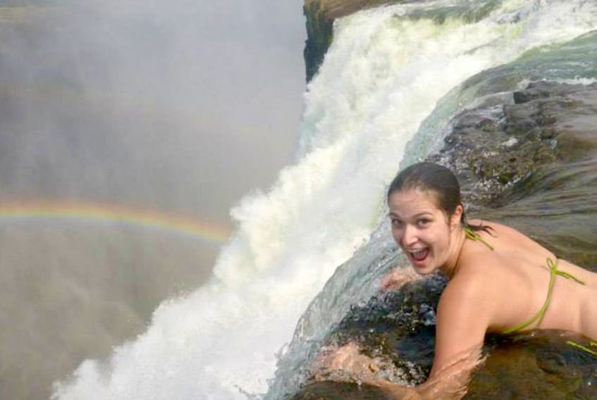 Kaitlyn Guinan had the opportunity to get close to the edge of Victoria Falls, on the Zambezi River along the border between Zambia and Zimbabwe, during a trip in 2013. Her feet were being held to ensure she didn’t go any farther forward.