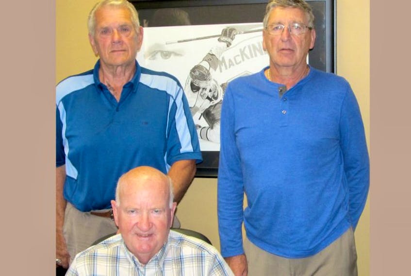 Stu Rath, seated, owner of the Truro Bearcats; new president, Gerry Hale, left, and retiring president Keith Mackenzie.