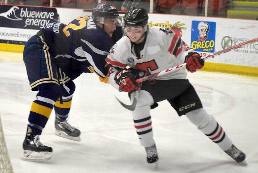 Truro Bearcats forward Cameron MacLeod is checked by Alex Mann of the Yarmouth Mariners during Game 1 action of a MHL first-round playoff series on Thursday. MacLeod netted two goals and assisted on another as the Bearcats skated to a 5-2 victory.