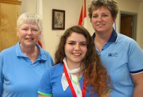 Girl Guide leaders Debbie Mellish, left, and Lorena Fortune, right, are seen with Olivia Hingley, a Pathfinder who earned her Canada Cord this year.